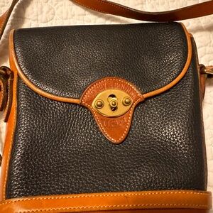 Vintage Dooney and Bourke black and tan leather cross body bag.